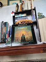 Overview of tiered rack with assorted books and basket below