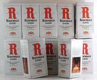 12 boxed Rodenbach Classic beer glasses stacked in 2 rows of 5 and 1 row of 2, showing the original packaging with branding and labels.