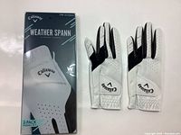 Box and two Callaway Weather Spann left hand women's golf gloves size S regular outside of packaging showing design and branding.