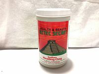Front view of sealed 2lb Aztec Secret Indian Healing Clay container showing brand, product name, and pyramid graphic.