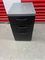 Front view of the 3 drawer metal filing cabinet with closed drawers and visible lock on top drawer.