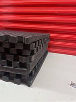Stack of 4 black foam mats showing thickness and interlocking edges