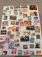 Full sheet showing multiple assorted international vintage stamps with a variety of colors, themes, and countries such as Bermuda, Hungary (Magyar Posta), Canada, Nederland, and India