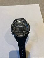 Front view of the Marathon digital watch showing the digital display and brand name on the face.