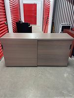 Front view of the office credenza sideboard showing two sliding doors and wood-like laminate finish.
