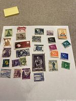 Scan of vintage Polska and assorted international postage stamps on a white album page, showing 28 stamps in multiple colors and designs