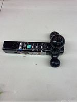 Full view of the Reese Tri-Ball trailer hitch showing the hitch mount with three hitch balls attached.