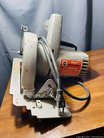 Side angle view of Black & Decker circular saw showing blade guard, handle, and cord.