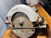 Side view of the Skil circular saw showing the metal blade guard and the 7 1/4 inch blade size.