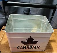 Angle view of the Molson Canadian metal bucket showing the logo, handle, and interior condition.