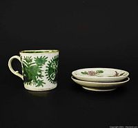 Antique ceramic cup with detailed green Fitzhugh floral motifs and three famille rose dishes shown together.