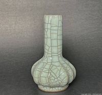 Front view of the garlic bottle vase showing the bulbous base and elongated neck with crackled Guan glaze.