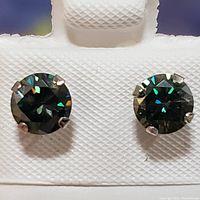 Front view of the pair of 10K white gold stud earrings featuring round cut moissanite stones with dazzling reflections.