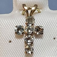 Close-up front view of the 10K yellow gold cross pendant displaying six round aquamarine stones arranged in a cross pattern, mounted with prongs on a yellow gold setting.