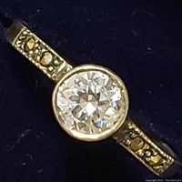 Close-up view of the ring's central cubic zirconia stone and marcasite detailing on the band