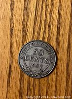 Reverse side of the 1907 Newfoundland silver 50 cent coin showing denomination, year, and word Newfoundland with decorative elements.
