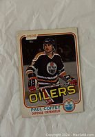 Front side of Paul Coffey rookie hockey card from 1981-82 O-Pee-Chee set showing player photo and team information.