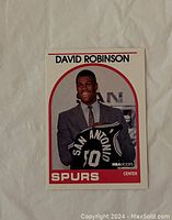 Front of the 1988-89 NBA Hoops rookie card featuring David Robinson holding a Spurs jersey.