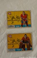 Front side of two 1968-69 O-Pee-Chee hockey cards featuring John Ferguson and Rogatien Vachon in Montreal Canadiens jersey.