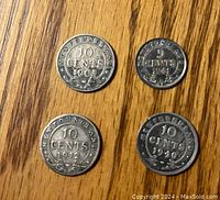 Obverse and reverse sides of four Newfoundland silver coins from early 20th century showing denominations and monarch profiles.