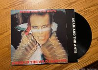 Front cover of Adam And The Ants Kings of the Wild Frontier vinyl album showing Adam Ant in costume with red text.