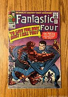 Front cover of Fantastic Four #42 comic showing characters in an action pose with bright colors, visible spine and edge wear.