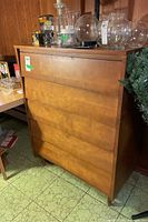 Back and side view of the dresser showing the finish and surface condition.