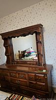 Front view of the vintage Kroehler wooden dresser with mirror showing detailed drawer fronts and mirror frame.