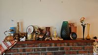 Shelf display with all lot items including vases, kettle, figurines, candle, wine chiller, and decorative plate shown together.