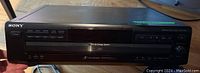 Sony CDP-CE215 5-disc CD changer front view showing brand and disc tray