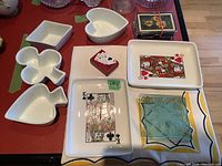 Top-down view of game-themed ceramic serve dishes and glass coasters on a table