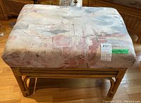 Top-down and angled views of the rattan foot rest ottoman with a patterned upholstered cushion in light tones, placed on a hardwood floor.