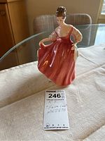 Front view of Royal Doulton Fair Lady figurine, showing rose-pink gown and detailed face and hair.