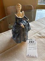 Front view of Royal Doulton figurine showing detailed dress and seated pose.