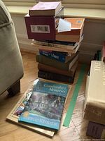 Stack of vintage and older hardcover and paperback books, including visible titles such as 'Grandmother's Memories To Her Grandchild' by Thomas Kinkade, with some books showing moderate age wear.