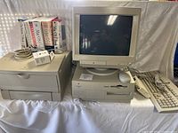 Full view of Power Macintosh tower, CRT display, printer, keyboard, mouse and software boxes