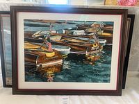 Main image showing three framed watercolor prints with wooden boats, front piece prominently visible and labeled 'California' on boat stern.