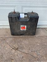 Closed black plastic carrying case with Commercial Electric logo on the front.