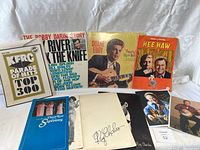 Overview of the lot showing several vinyl records, a large KFRC top 300 poster, booklets including Diana Ross Supremes and Ray Charles memorabilia, plus some photo cards.