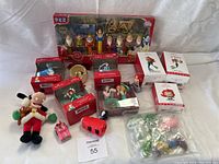 Photo showing all Disney items including Snow White PEZ set, Hallmark ornaments, plush Mickey, and small toys