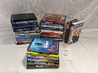 Full view of the movie collection showing DVDs and VHS tapes stacked together