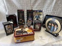 Full view of Elvis collectibles including figurines, miniature guitars, decorative tin, Beatles plate, and boxed items