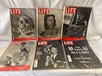 Six vintage Life magazines with various covers including a baby, a woman, a pilot, a dressed woman, Robert Kennedy, and a psycho-biology of violence cover.