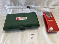 Close-up of Matco Tools HP-2 riveter with red handles inside the green case with rivet boxes.