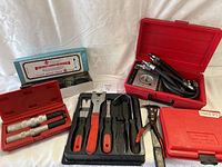 Overview of lot: red and blue cases plus panel removal tools laid out