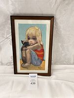 Full view of framed Margaret Keane print depicting girl with large eyes holding cat.