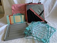 Photo showing the pink insulated lunch bag, gray and black lunch cooler bag, turquoise wire baskets, gray plastic slat organizer, and colorful picture frames arranged together