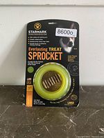 Front of the sealed packaging showing the Starmark Everlasting Treat Sprocket for large dogs. The packaging states it is chicken flavored and helps clean teeth.