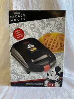 Box of the Disney Mickey Mouse waffle maker showing product image and branding.