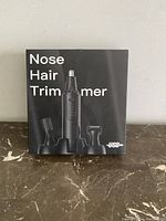 Front photo of the product box showing the nose and hair trimmer with attachments, brand 'USB'.